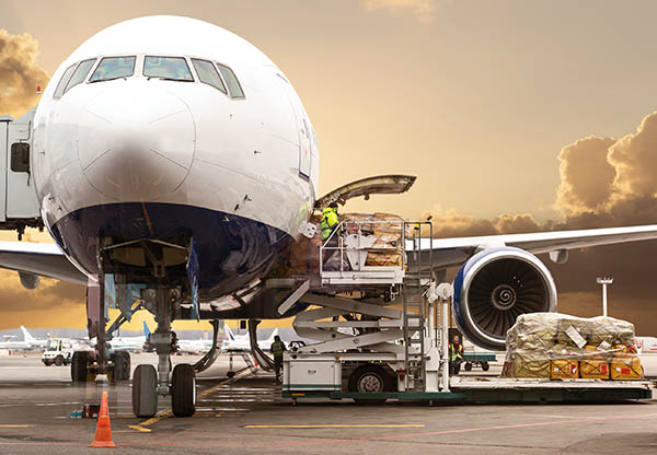 Loading cargo on the plane in airport, view through window