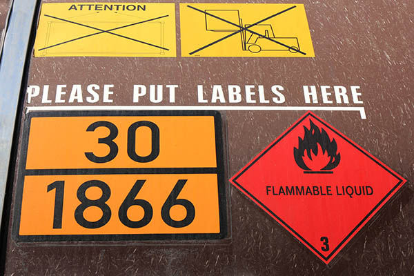 orange-colored plate with hazard-identification number 30 and UN-Number 1866 (resin solution, flammable