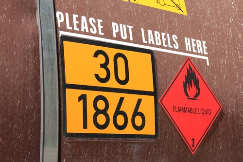 orange-colored plate with hazard-identification number 30 and UN-Number 1866 (resin solution, flammabl