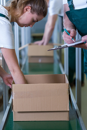 woman packaging product on assembly line
