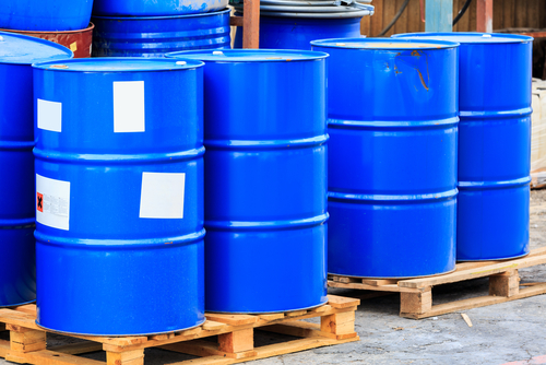 blue storage barrels on wooden pallets