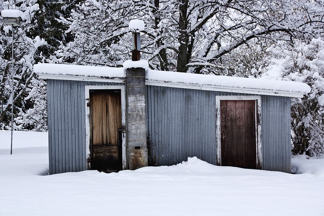 gray shack covered in snow