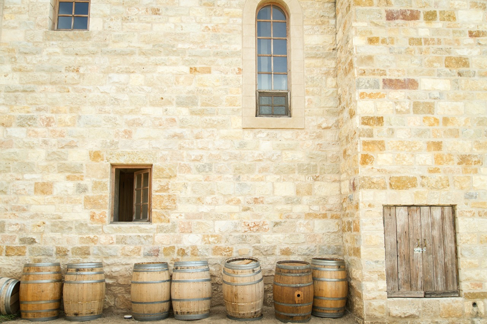 row of wooden barrels outside old building