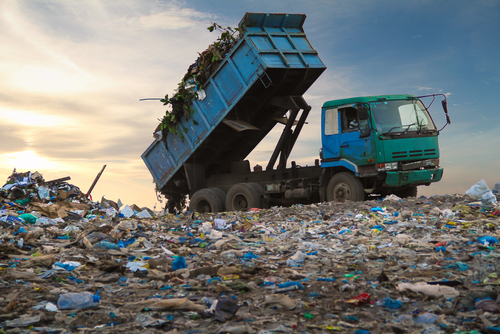 dump truck unloading waste at landfill