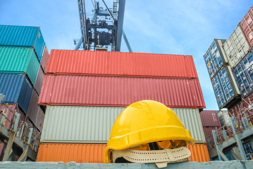 yellow safety helmet before shipping containers