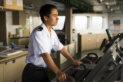 young chinese navigator surveying navigation devices