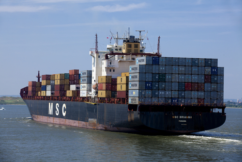 The stern of a cargo ship MSC Brianna registered to Panama stacked with steel cargo containers