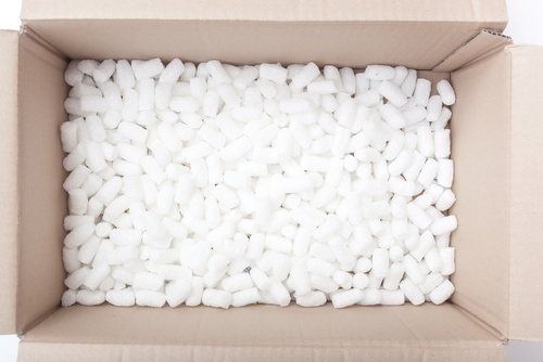 Large packaging box filled with many white styrofoam pellets