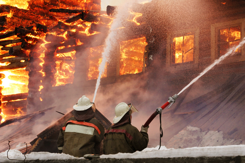 firefighters extinguishing structural fire