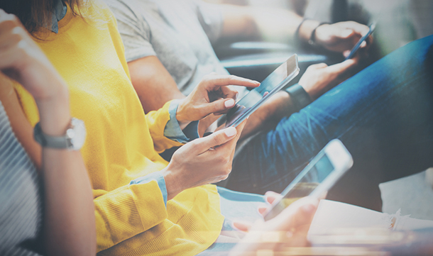 group people sitting smart devices