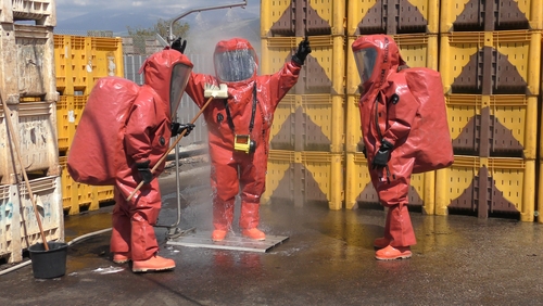 firefighters clean up in protective suits