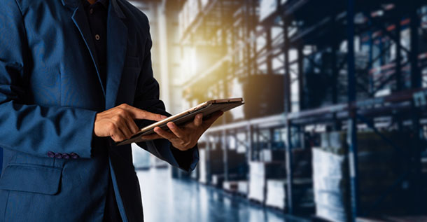 man using tablet in warehouse