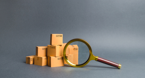 pile of boxes and magnifying glass