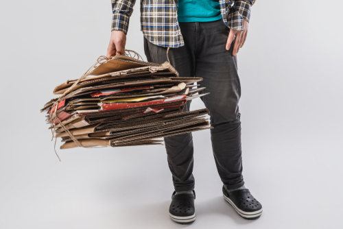 man holding used cardboard boxes