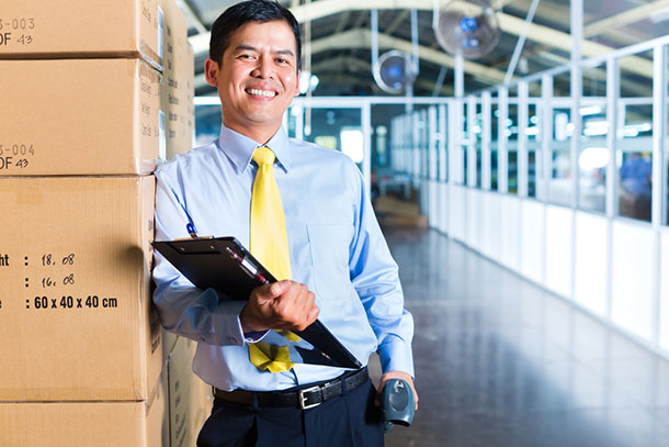 manager holding clipboard in warehouse