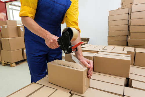 worker packing box with tape