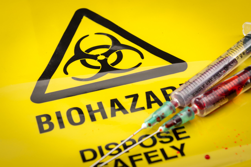 syringes over biohazard warning