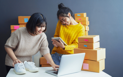 two employees packaging boxes online orders