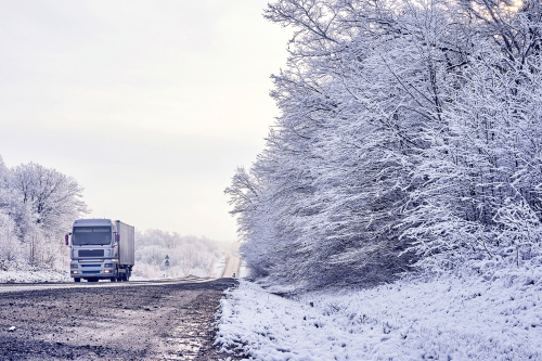 truck traveling on winter road