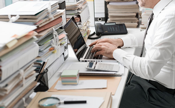 filling out paperwork using laptop