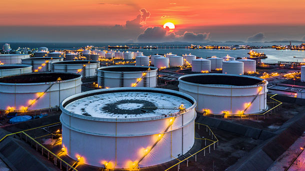 Aerial top view storage tank farm at sunset, Tank farm storage chemical petroleum petrochemical refinery product at oil terminal, Business commercial trade fuel and energy transport by tanker vessel.