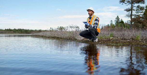 Marine biologist analysing water test results on a tablet in Can