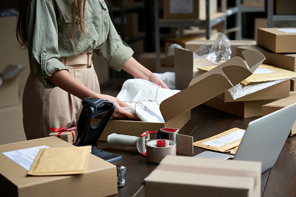 a woman filling a shipping order at a business