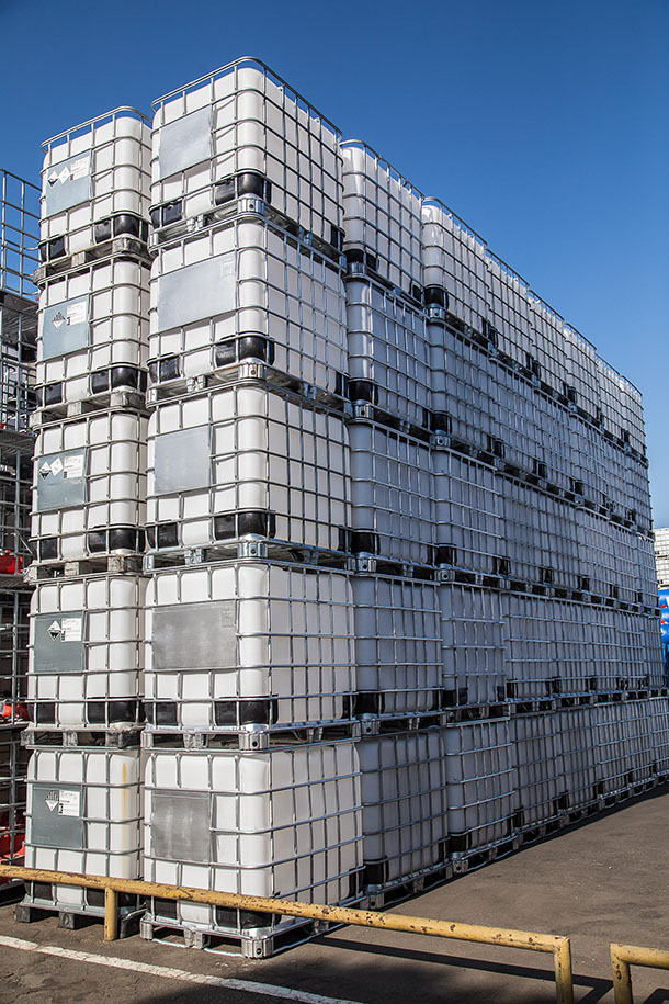 stacked IBCs being stored outside